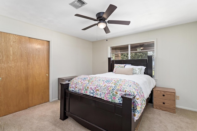 carpeted bedroom featuring visible vents, baseboards, a closet, and ceiling fan