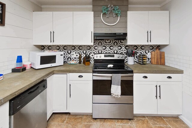 kitchen with white cabinets, stainless steel appliances, ornamental molding, and exhaust hood