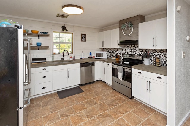 kitchen with stainless steel appliances, white cabinetry, ornamental molding, and sink