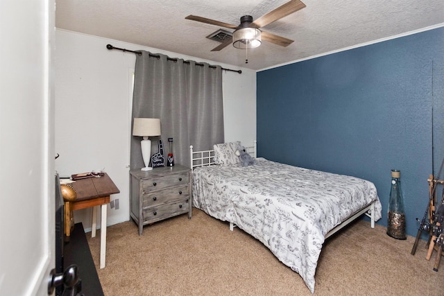 carpeted bedroom featuring ceiling fan, crown molding, and a textured ceiling