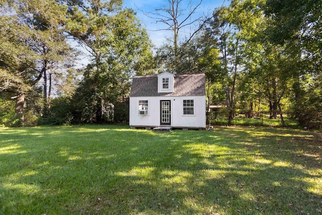 view of outbuilding with a yard