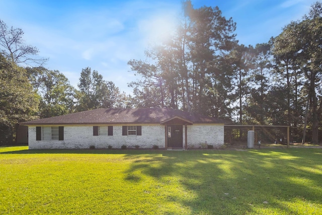 rear view of property featuring a yard