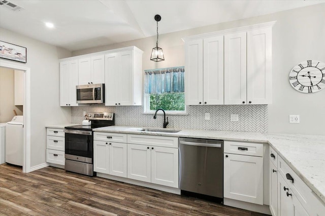 kitchen with light stone countertops, sink, white cabinets, and appliances with stainless steel finishes