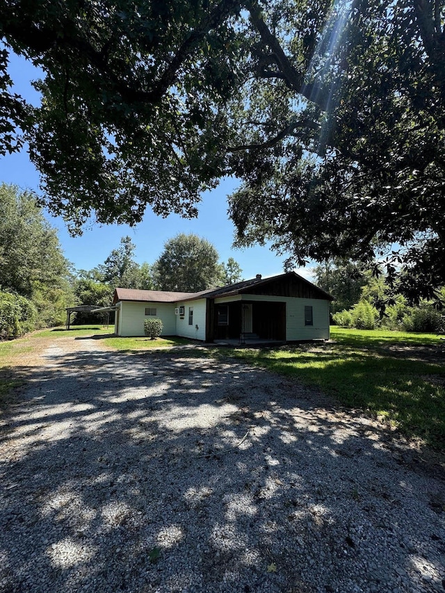 view of front facade with a carport and a front yard