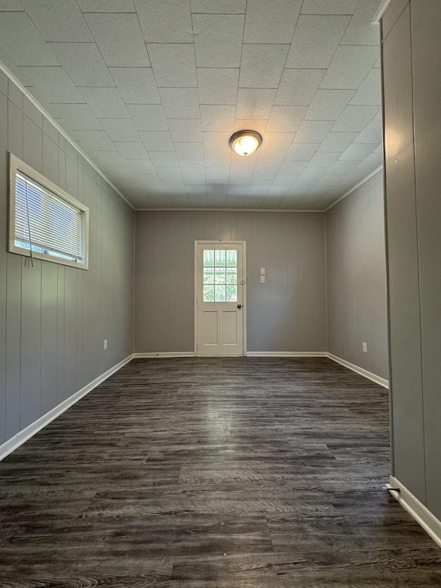 unfurnished room with dark wood-type flooring