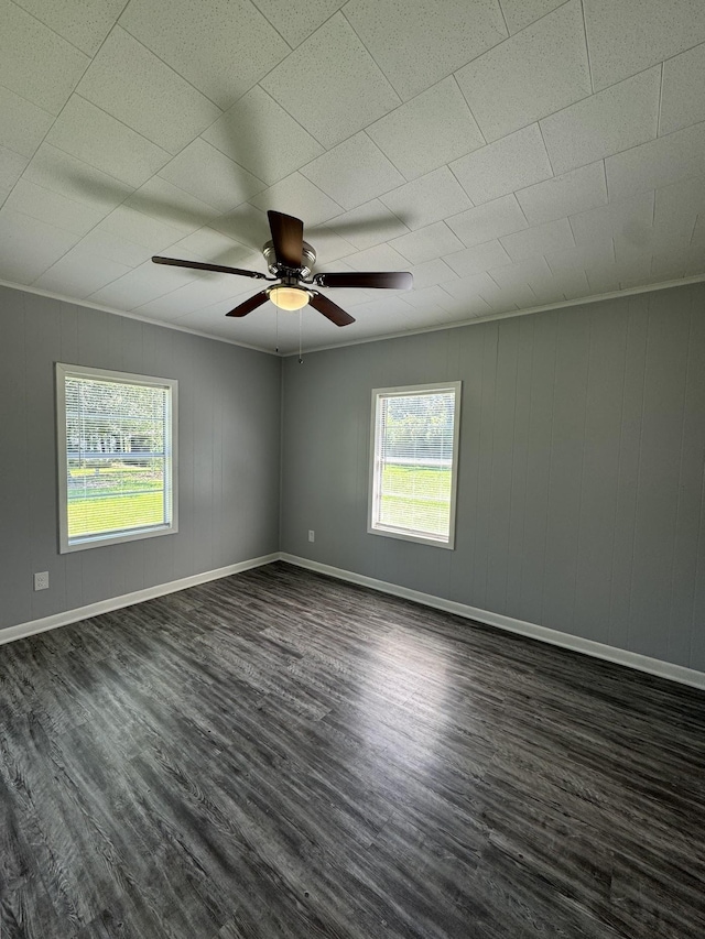 spare room featuring dark hardwood / wood-style floors and ceiling fan