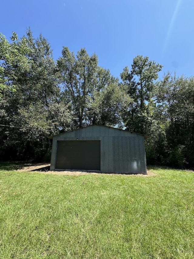 view of outbuilding featuring a yard and a garage