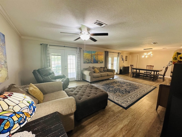 8594 Morgan Ln, Orange, TX 77632 - living area with ornamental molding, wood finished floors, a chandelier, a textured ceiling, and a ceiling fan