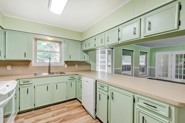 kitchen with white dishwasher, kitchen peninsula, sink, and range