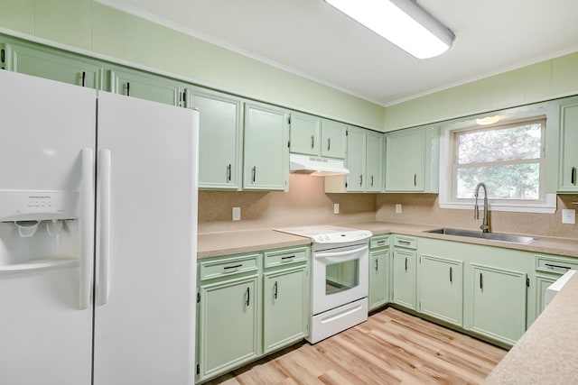 kitchen featuring green cabinets, crown molding, sink, and white appliances