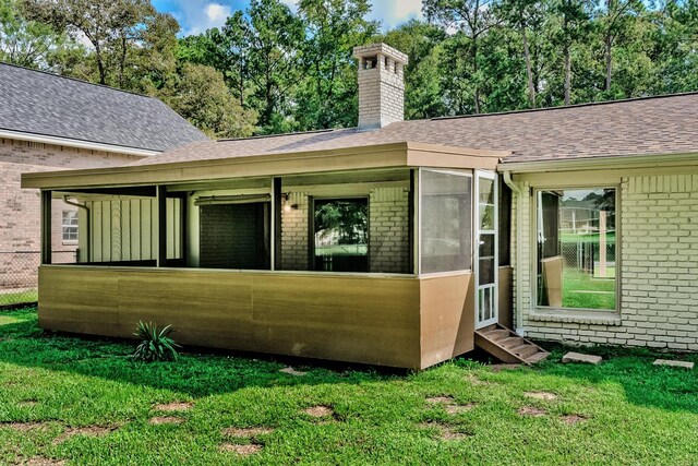 back of house featuring a yard