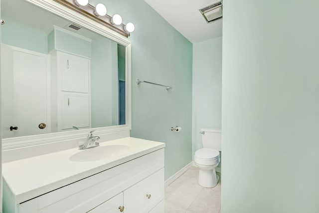 bathroom with tile patterned flooring, vanity, and toilet