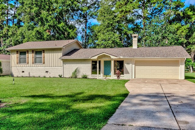 ranch-style house with a garage and a front lawn