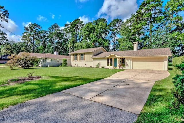 split level home with a garage and a front lawn