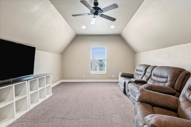 carpeted living room with ceiling fan and lofted ceiling