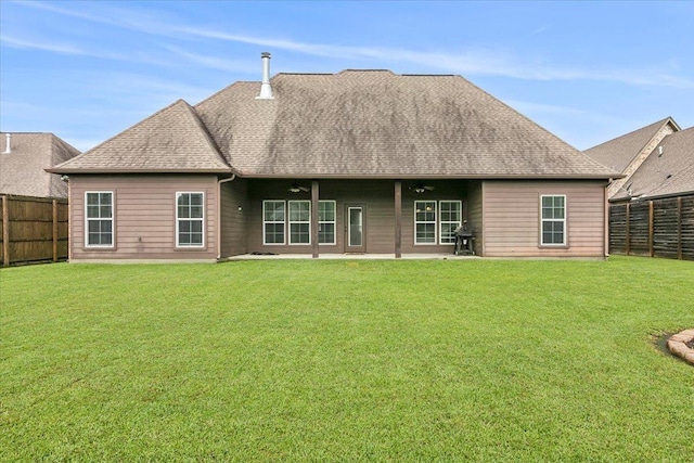 rear view of property featuring a yard and a patio