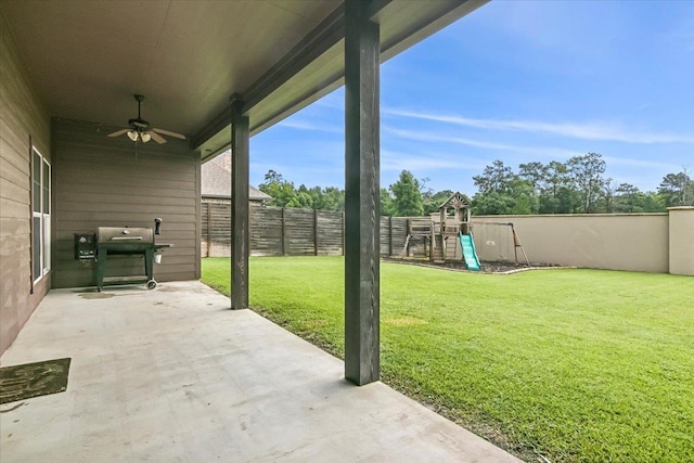 view of patio featuring grilling area, a playground, and ceiling fan