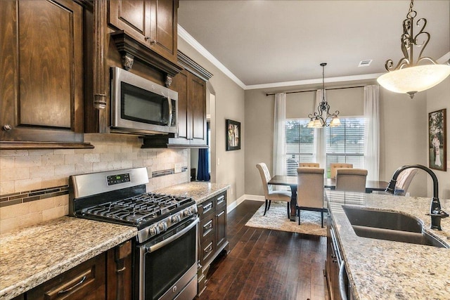 1390 Kalas Cir, Lumberton, TX 77657 - kitchen featuring stainless steel appliances, a sink, dark wood-style floors, crown molding, and dark brown cabinets