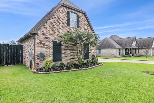 view of side of home with a lawn