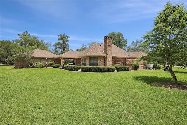4711 Burns Cir, Orange, TX 77630 - view of front of property featuring a front lawn, a chimney, and brick siding