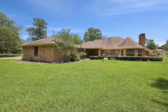 4711 Burns Cir, Orange, TX 77630 - ranch-style home with brick siding, a front lawn, and a chimney