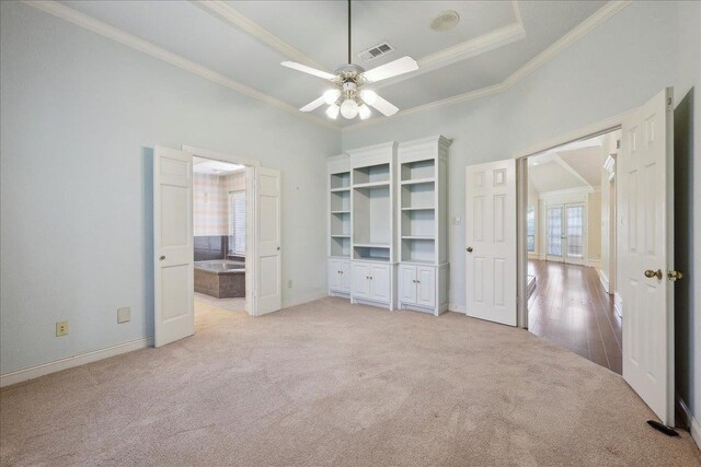 4711 Burns Cir, Orange, TX 77630 - unfurnished bedroom featuring light colored carpet, crown molding, baseboards, a tray ceiling, and ensuite bath