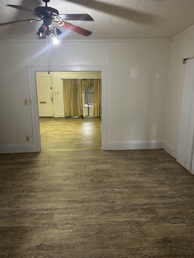 empty room featuring ceiling fan, dark hardwood / wood-style flooring, and ornamental molding