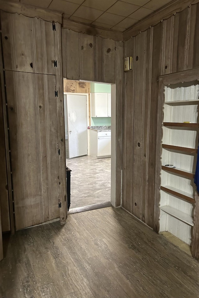 unfurnished room with wood-type flooring and wooden walls