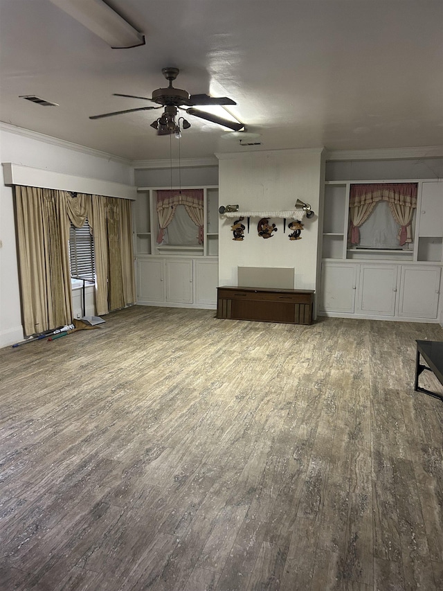 unfurnished living room with crown molding, ceiling fan, and hardwood / wood-style flooring