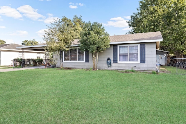 single story home with fence, a carport, and a front yard