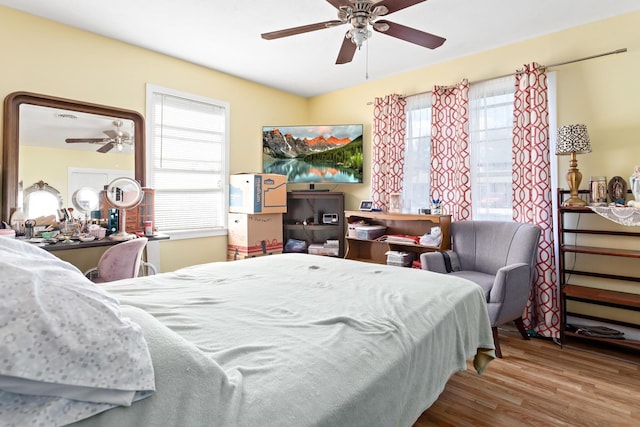 bedroom with ceiling fan and wood finished floors