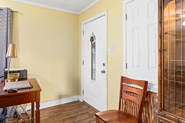 entryway featuring crown molding, wood finished floors, and baseboards