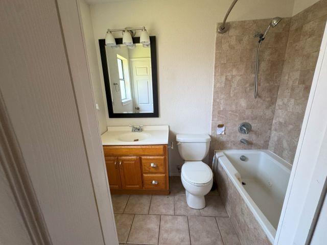 2985 Willow Pl, Beaumont, TX 77707 - full bath featuring vanity, tiled shower / bath, and tile patterned floors