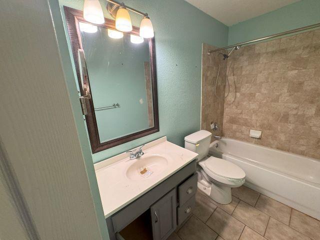 2985 Willow Pl, Beaumont, TX 77707 - bathroom with vanity, shower / bath combination, and tile patterned flooring