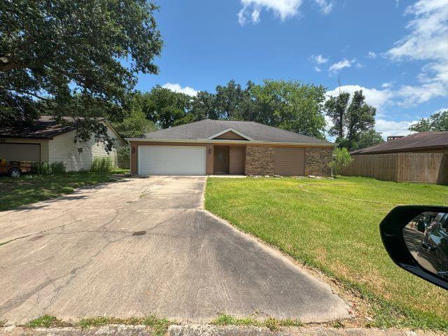 2985 Willow Pl, Beaumont, TX 77707 - single story home featuring an attached garage, concrete driveway, and stone siding