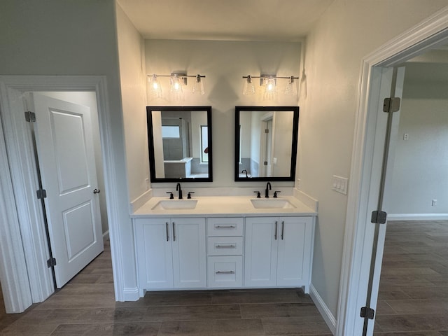 14865 Norma Jane Ln, Beaumont, TX 77713 - full bath featuring wood finished floors, double vanity, and baseboards