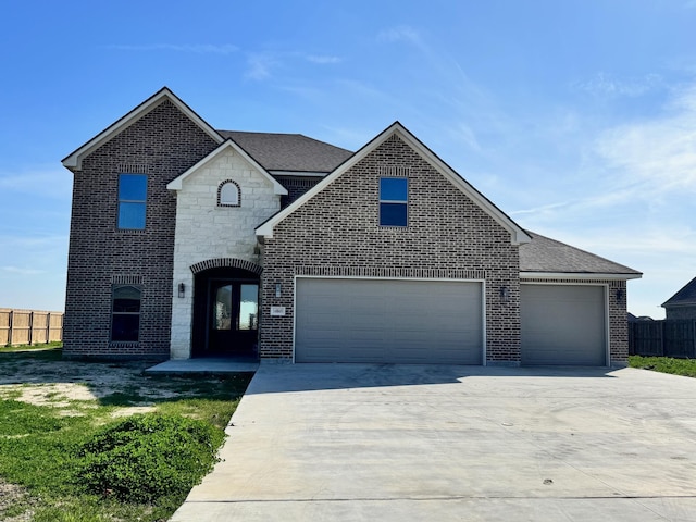 view of front of property featuring driveway, a garage, fence, and brick siding