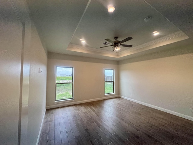 14865 Norma Jane Ln, Beaumont, TX 77713 - spare room featuring a tray ceiling, crown molding, dark wood-type flooring, baseboards, and a ceiling fan