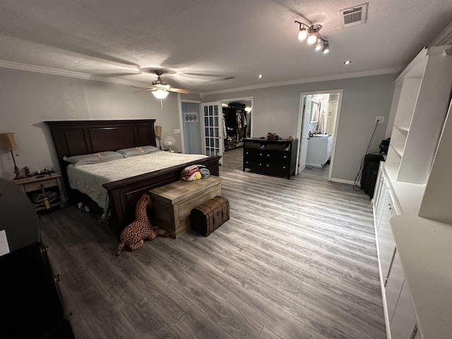 bedroom featuring a textured ceiling, hardwood / wood-style flooring, ceiling fan, and crown molding