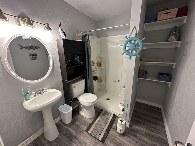 bathroom featuring toilet, hardwood / wood-style floors, and a shower with curtain