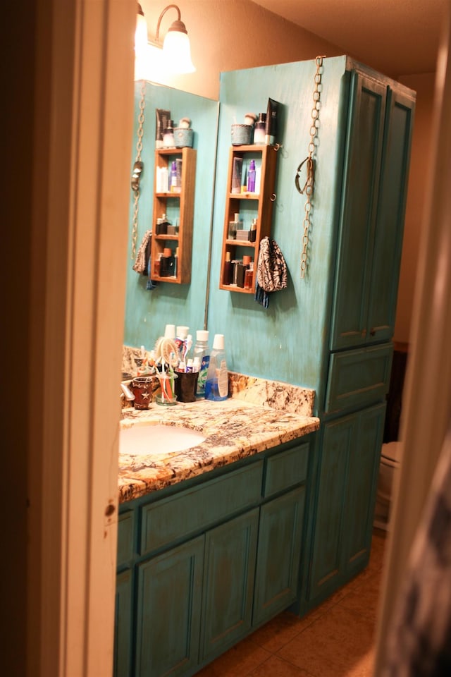 bathroom with tile patterned floors, vanity, and toilet