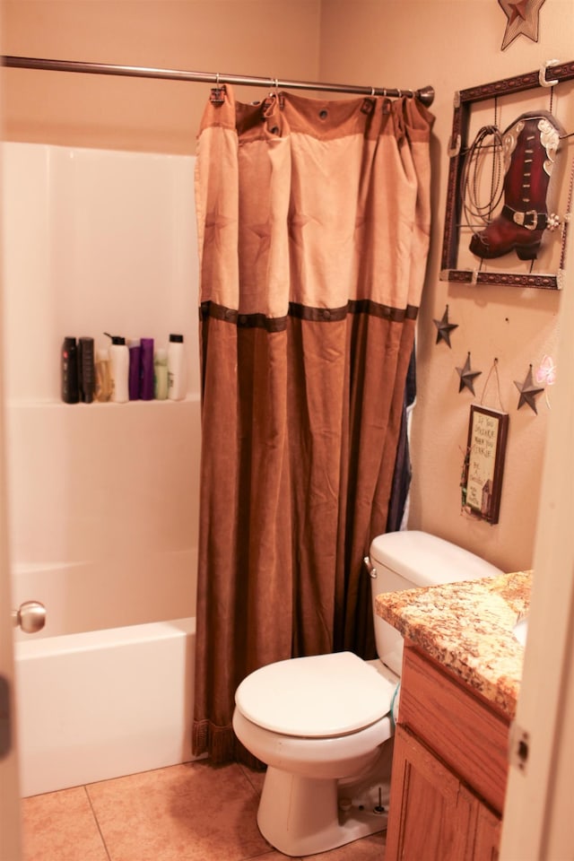 full bathroom featuring toilet, tile patterned floors, vanity, and shower / bath combo with shower curtain