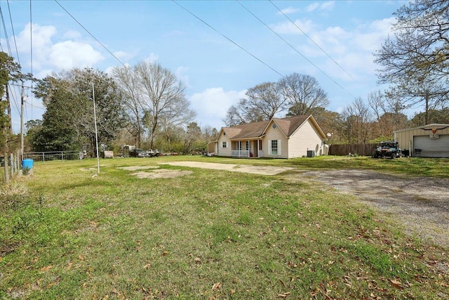 view of yard with driveway and fence