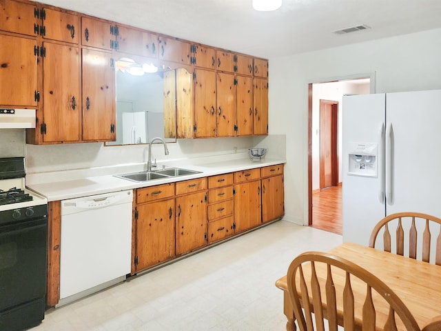 kitchen featuring white appliances and sink