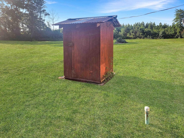 view of outbuilding with a lawn