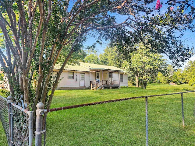 view of front of property with a wooden deck and a front lawn