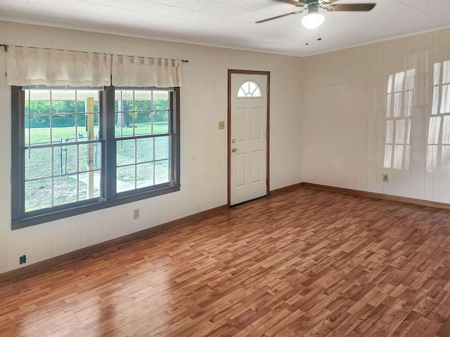 entryway with hardwood / wood-style flooring, ceiling fan, and crown molding