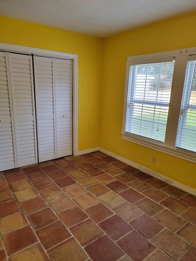 unfurnished bedroom with a closet