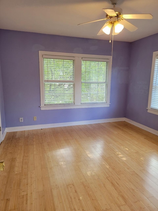 unfurnished room with light hardwood / wood-style flooring, ceiling fan, and plenty of natural light