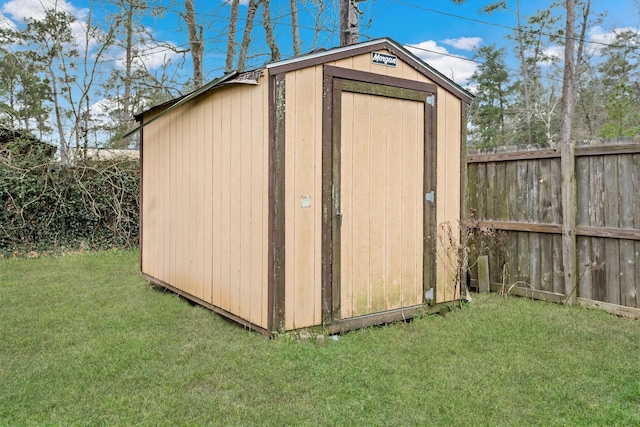 view of shed featuring fence